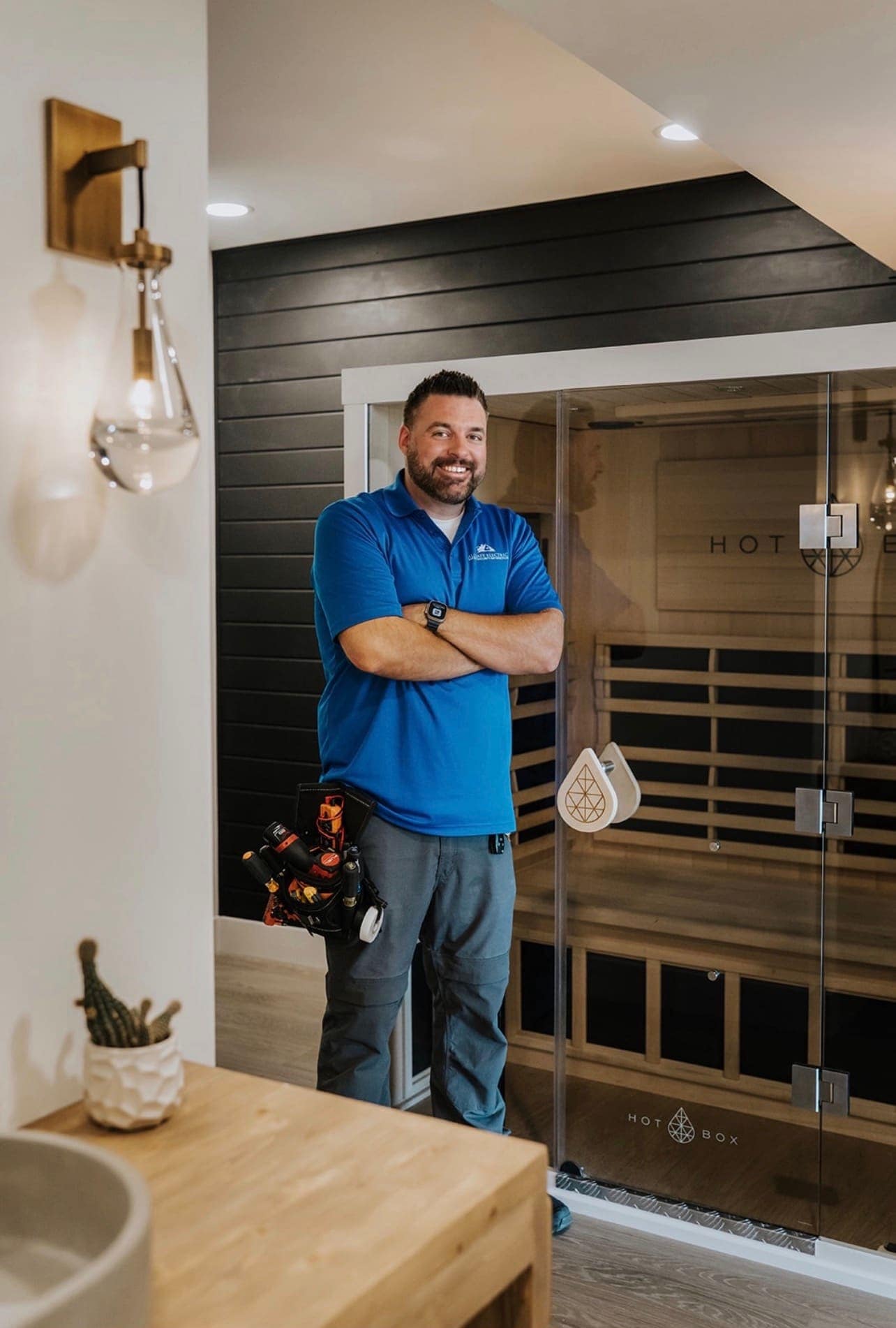 An Allsafe Electric electrician beside installed equipment at a Parker home