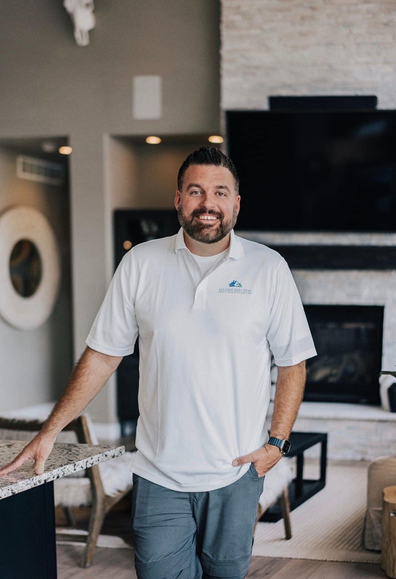 An Allsafe Electric electrician in the hallway of a modern Parker home