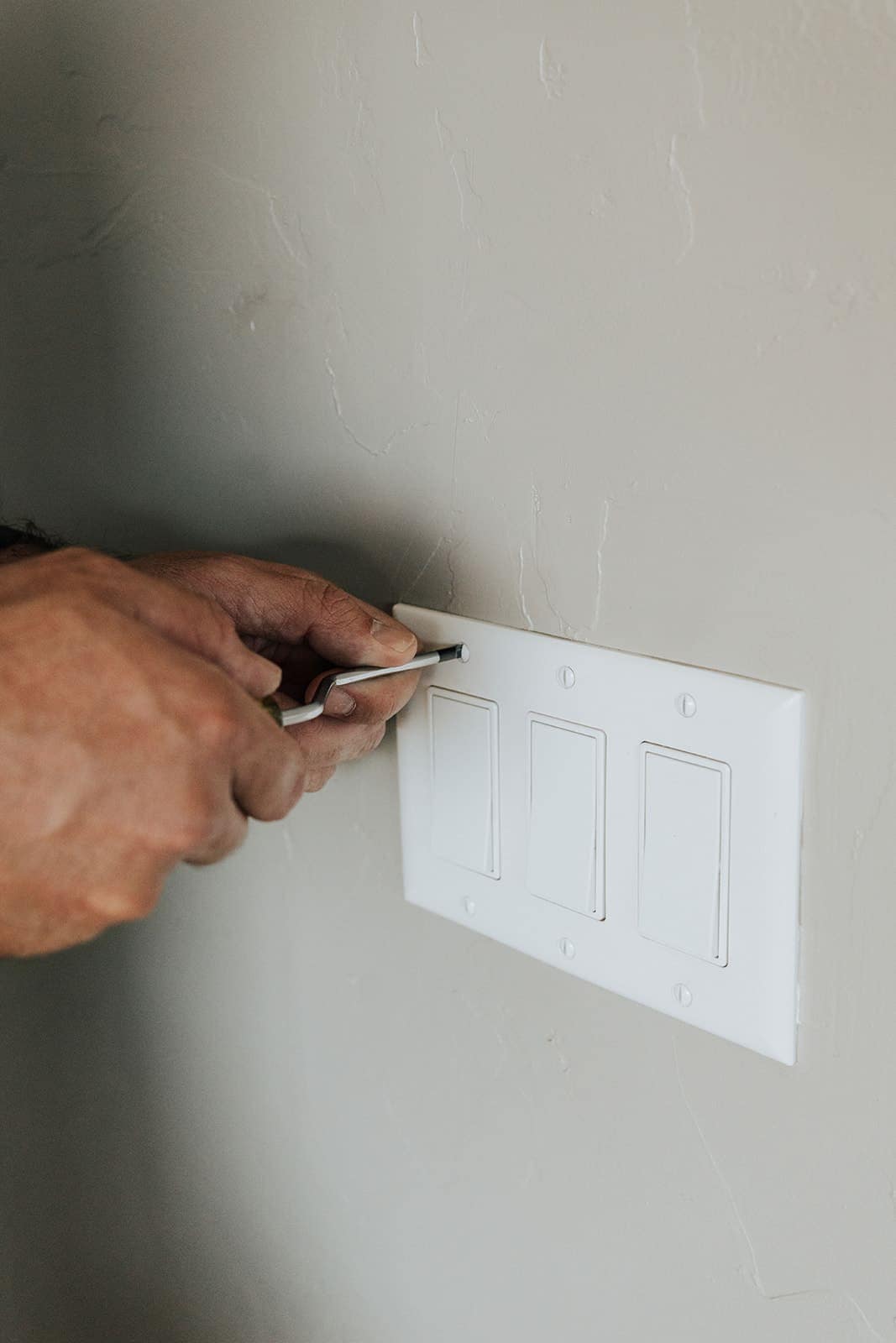 Fitting a three-gang switch plate over newly installed light switches