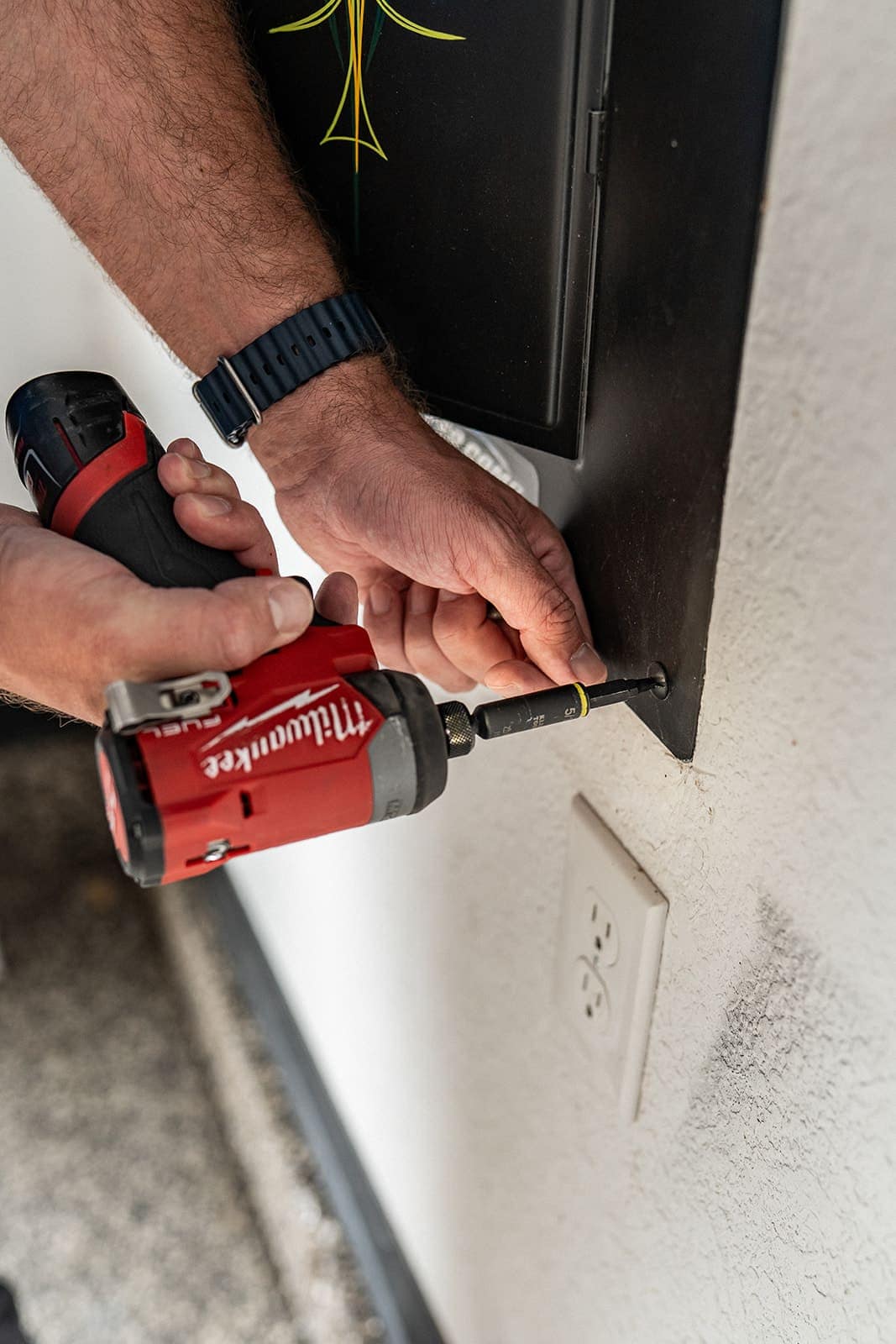 Allsafe electrician removing a breaker panel cover during an emergency call