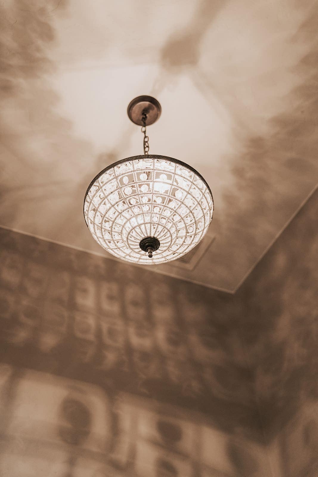 A decorative bowl chandelier lit after installation