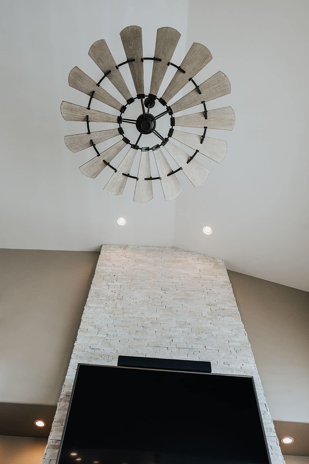 A large windmill-style ceiling fan installed in a living room
